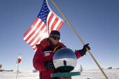 Denise with the Stars & Stripes at the Ceremonial South Pole. Antarctica