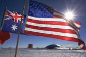The Stars & Stripes flies with the Flags of Nations at the Ceremonial South Pole & the Dome. Antarctica