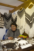 Woman selling knitwear made from wool or Alpaca in a craft market close to the harbour. Ushuaia. Antarctica