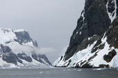 Stratus cloud hugs the mountains at the side of the Lemaire Channel. Antarctica