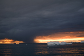 Heavy nimbostratus cloud and a snow squall amongst the icebergs in Marguerite Bay. Antarctica