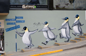 A mural of fat penguins down a side street in Ushuaia. Argentina