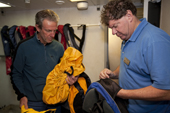 Expedition Staff Milton checks passengers clothing for seeds and Guano prior to an Antarctic Landing