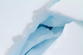 Layers of snow covered ice with a dark blue interior. Antarctica