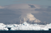 Mountainous, ice covered islands, the South Orkneys seen over pack ice. Antarctica