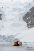 Tourist Zodiac approaches a glacier on the the Whittle Peninsula on the Antarctic Peninsula.