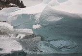 Texture on a piece of clear iceberg ice transmits the light at different angles. Antarctica