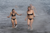 Tourists swim at Whalers Bay. Deception Is. South Shetland Is. Antarctica