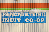 In the Spring Icicles hang from the Co-op sign in Pangnirtung. Nunavut, Canada. 2008