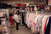 Inuit mother shopping for clothes at a store in Igloolik, Nunavut, Canada. 1990