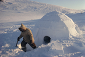 Aipilik, An Inuit hunter, outside his igloo during a fishing trip. Igloolik, Nunavut, Canada. 1990
