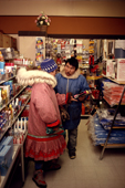 Kigutikaarjuk & his wife Annie, discuss their purchases in the shop at Igloolik. Nunavut, Canada. 1990