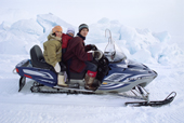 Rebecca Akumalik, an Inuit woman from Arctic Bay, out on a snowmobile with her two daughters. Nunavut, Canada. 2005