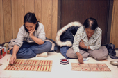 Inuit women play Bingo on the floor of the village hall. Baker Lake. Nunavut. Canadian Arctic. 1982