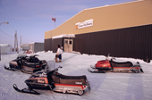 Snowmobiles parked outside the Hudson Bay Store in the snow. Baker Lake. Nunavut. Canadian Arctic. 1982