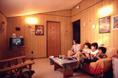 Inuit mother and her family watch television in their home in Baker Lake. Nunavut. Canadian Arctic. 1982