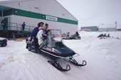 Inuit family on Snowmobile outside the Northern Store at Igloolik, Nunavut, Canada. 1992