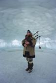 John MacDonald, a Scot who lives in Canada's arctic, playing the bagpipes in a large igloo.Nunavut, Canada. 1999