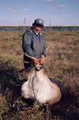 Abel Brien, a Cree hunter with a caribou he has shot. Sub-Arctic, Quebec, Canada. 1988
