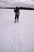Abel Brien, a Cree hunter wearing snow shoes to aid his walking leaves dramatic footprints. Quebec, Canada. 1988