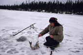 Cree woman, Elizabeth Brien, checks her fishing nets under the ice of Lake Bourinot. Quebec. Canada. 1988