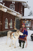 A Sami man with his reindeer at Santa Claus Village near Rovaniemi. Finland