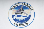 Sign of the Nation Park of Galapagos incorporates a Giant Tortoise and a hammerhead shark,
