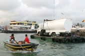 Transporting a small tanker truck on a pontoon to the docks in Puerto Ayora, Santa Cruz. Galapagos