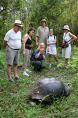 Visitors to the the Primicias Farm photograph Giant tortoise, Geochelone elephantophus porteri, in the wild. Santa Cruz. Galapagos.