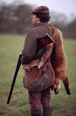 Wildlife sculptor Geoffrey Dashwood with a dead fox over his shoulder. Hampshire England
