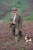 Grouse keeper C. Adamson on a shoot day with dog & radio Scotland