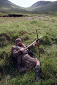 Highland stalker, Bob Bisset on the moor with his stick and spyglass. Glen Lyon, Perthsire. Scotland.