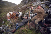 Deer Stalker Robin Rolfe spies for deer in the highlands, the pony will carry the body. Scotland