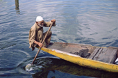An elderly Kashmiri man paddling a shikara (traditional boat) on Lake Nagin. Kashmir, India. 1986