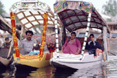 Indian families relax in shikaras (traditional boats) they have hired on Dal Lake. Srinagar, Kashmir, India. 1986