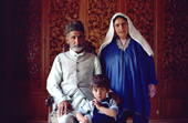 An elderly Kashmiri couple pose with their grandson in a houseboat on Lake Nagin. Kashmir, India. 1986