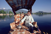 A Kashmiri in a Shikara smoking a Hooka on Lake Nagin. Kashmir, India. 1986