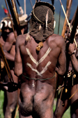 Yali warriors, wearing head-dresses and carrying bows & arrows, dance at a feast. Irian Jaya, Indonesia. 1990