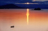 Anglers in a small boat at sunset in Favorite Passage with Cohen Is. & the Chilkat Mountains behind. SE.Alaska.