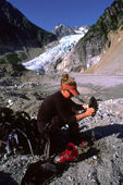 Instructor, Noelle Bovon, empties her boots after crossing West Creek. Coast Ranges, Alaska.