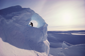 Ian Marriott arranges a belay in a wind blown cave in the 'Hinge Zone', Brunt Ice Shelf, Antarctica.