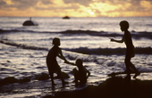 Children playing on the beach at sunset. Anibare Bay. Nauru. The Pacific.