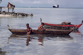 Young boys on a traditional canoe. Ifalik Atoll, Yap, Caroline Islands, Micronesia, Pacific. 1996
