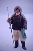 Inuk, Ituko, dressed in fox parka & polar bear pants, holding a harpoon. N.W. Greenland. 1980