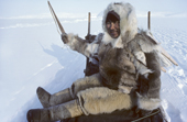 Inuit hunter, Qaavigannguaq Qissuk, dressed in furs and travelling by dog sled. He wears a caribou skin jacket, polar bear pants and sealskin kamik (boots). Avanersuaq, Northwest Greenland. 1980