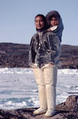 Eqilana Simigaq, an Inuit woman, carries her son in a sealskin amaut (hooded jacket).Qeqertat, Northwest Greenland. 1980