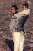 Eqilana Simigaq, an Inuit woman, carries her son in a sealskin amaut (hooded jacket).Qeqertat, Northwest Greenland. 1980