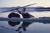 Inuk, Nukagpianguaq in kayak uses throwing board to hurl his harpoon. NW Greenland. 1980