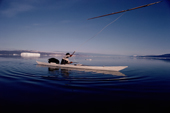 Nukagpianguaq, an Inuit hunter, in his kayak uses a throwing board to hurl his harpoon. NW Greenland. 1980
