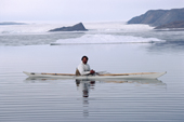 Jakob, An Inuit hunter, out in his kayak in the calm summer waters of Inglefield Bay. Northwest Greenland. 1980